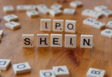 Creative representation of Shein's IPO using letter tiles on a wooden surface.