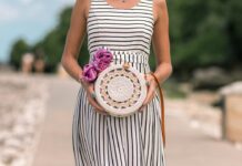 woman wearing white and black striped dress holding white and brown bag